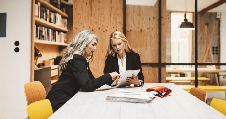 Two businesswomen meeting in a conference room.